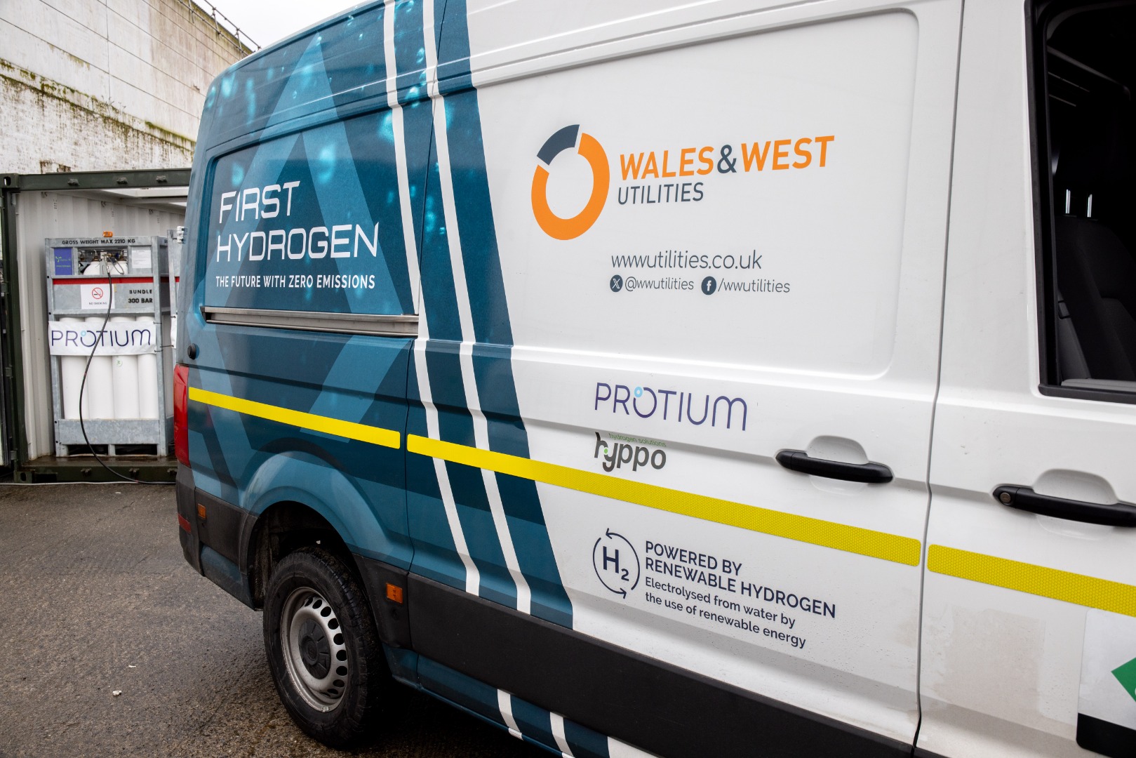 side view of white hydrogen van with blue pattern